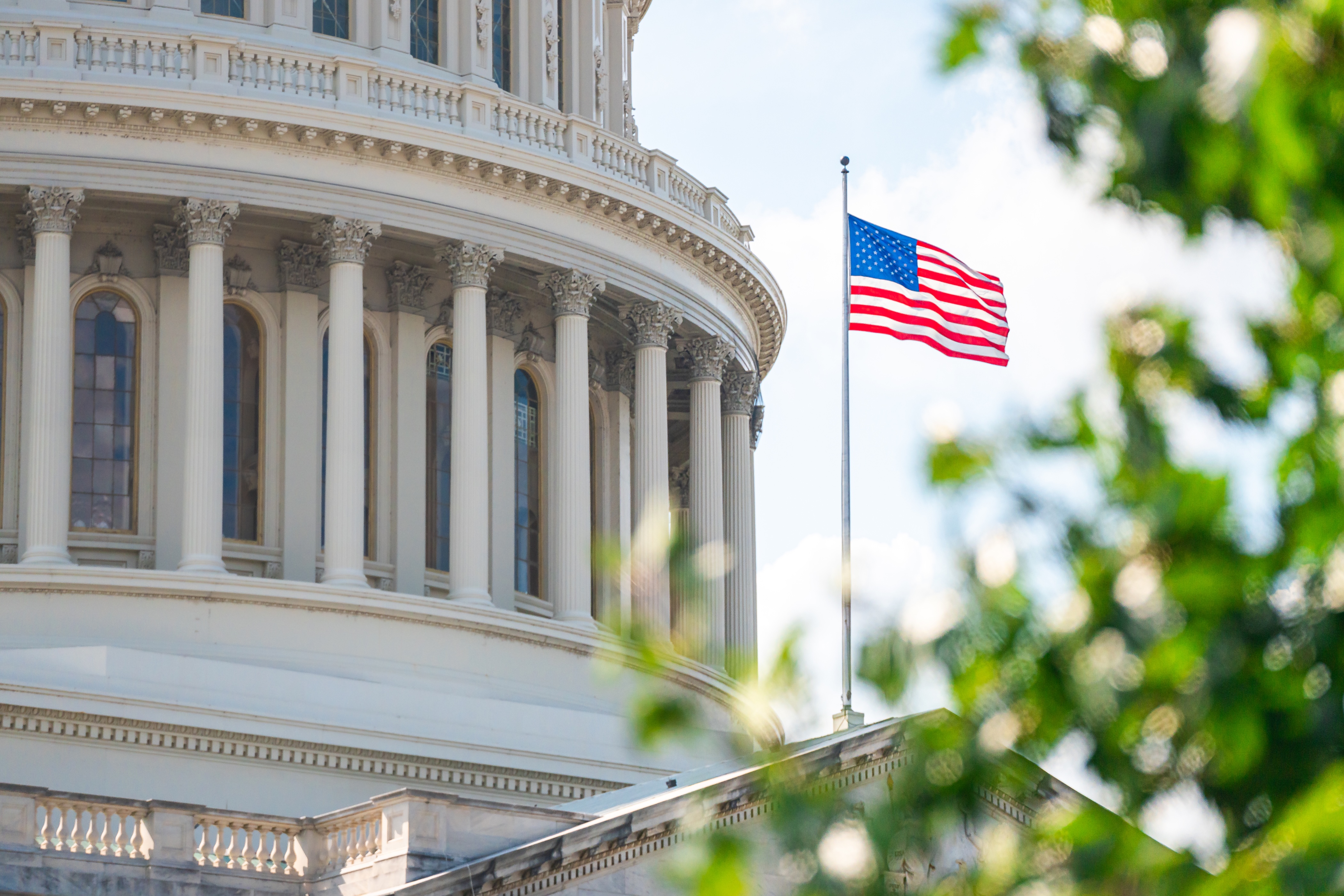 The United States Capitol dome with an American flag